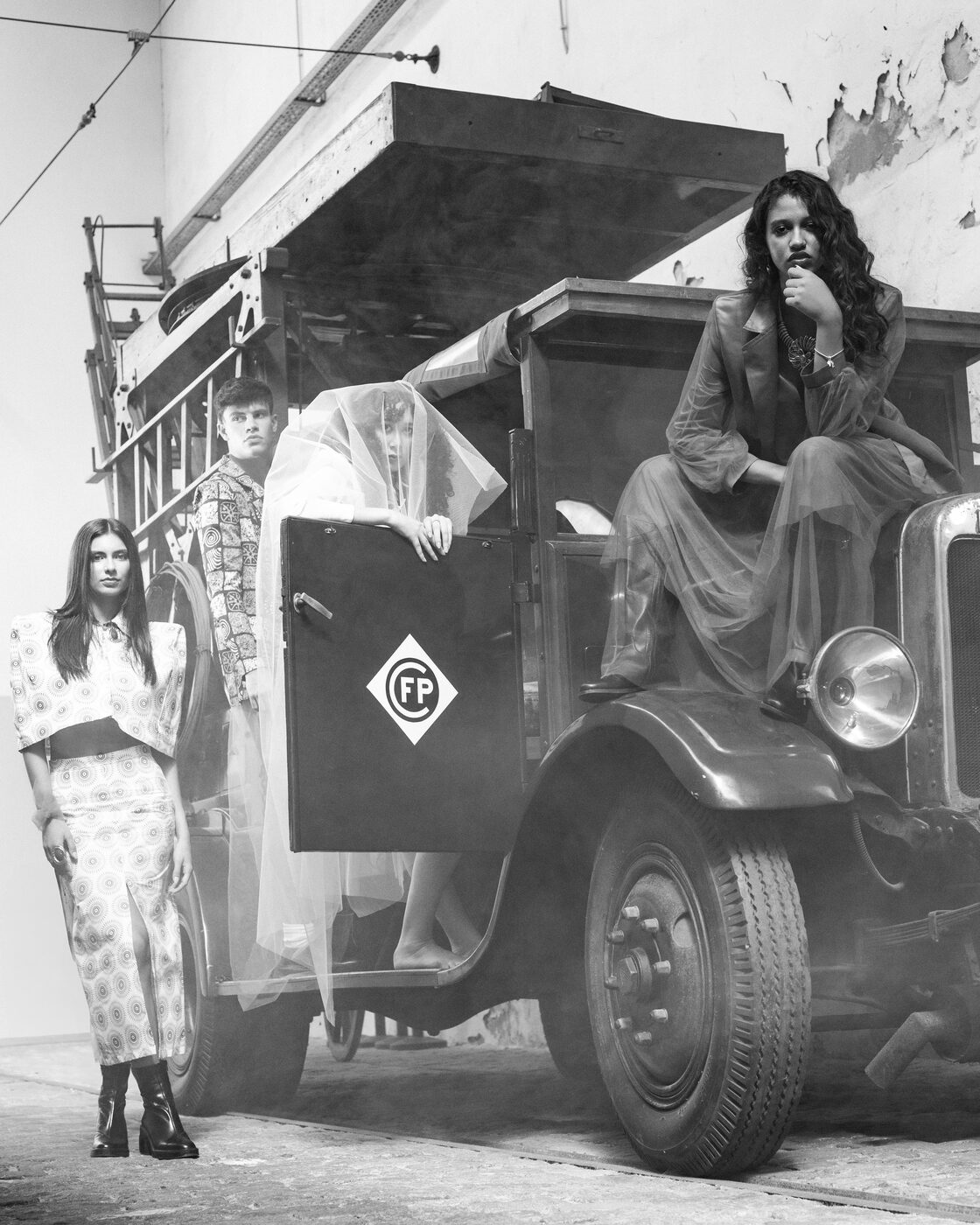 Fotografia a preto e branco: quatro looks da coleção em torno do camião vintage, com véu e fumo